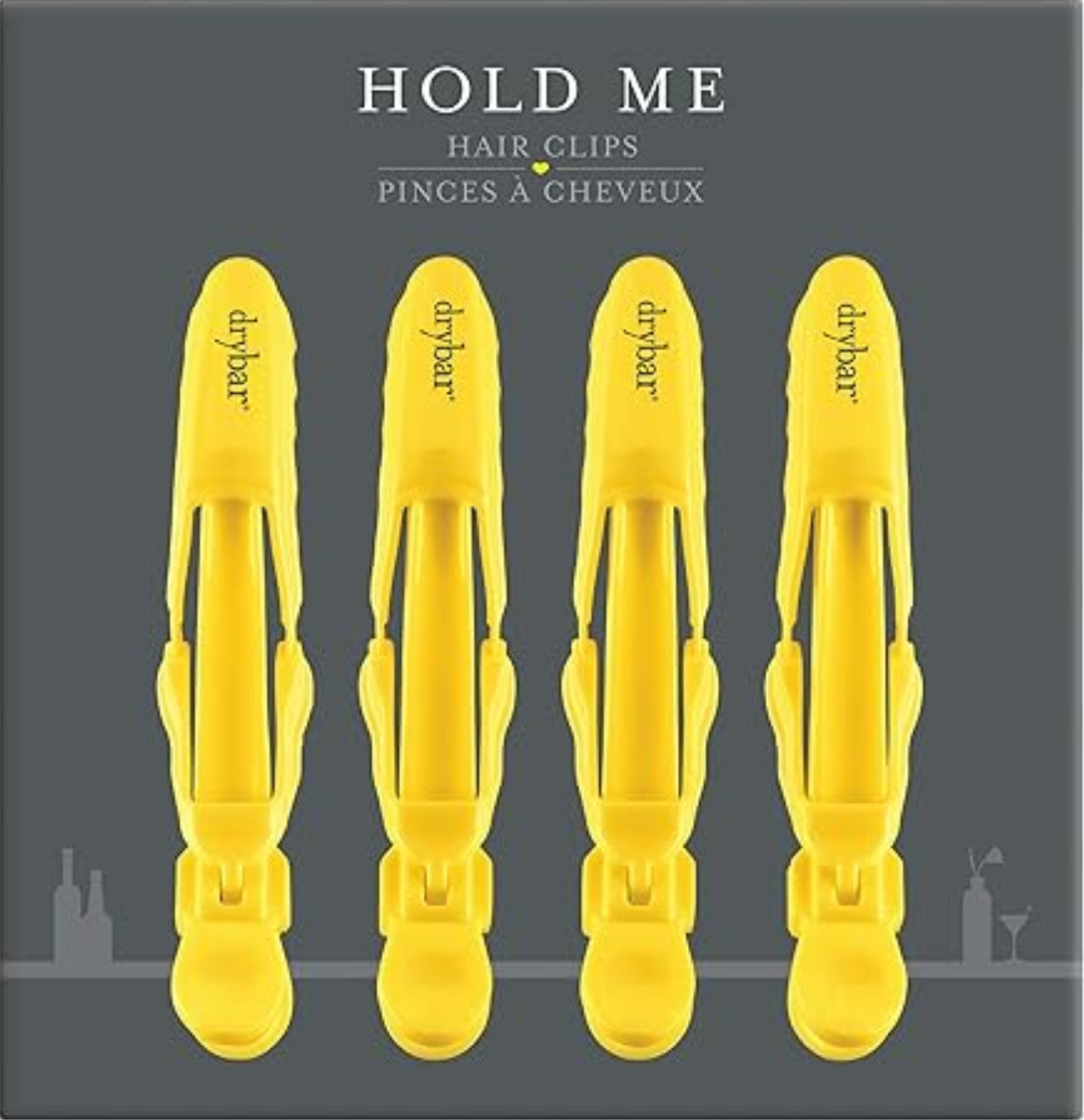 Four yellow Drybar Hold Me sectioning clips with strong grip and heat resistance for pro styling sessions
